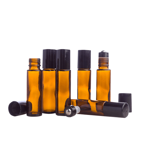 Set of amber glass roller bottles with black caps on a white background