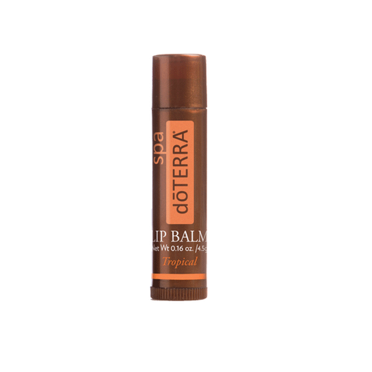 A tube of dôTERRA Spa Lip Balm (Tropical) with orange and brown color scheme.