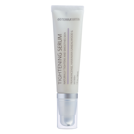 A tube of doTERRA Tightening Serum with white and purple labeling, indicating the product is formulated with essential oils.